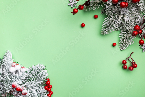 Christmas holidays composition with christmas decorations and fir tree branches on green background with copy space for your text