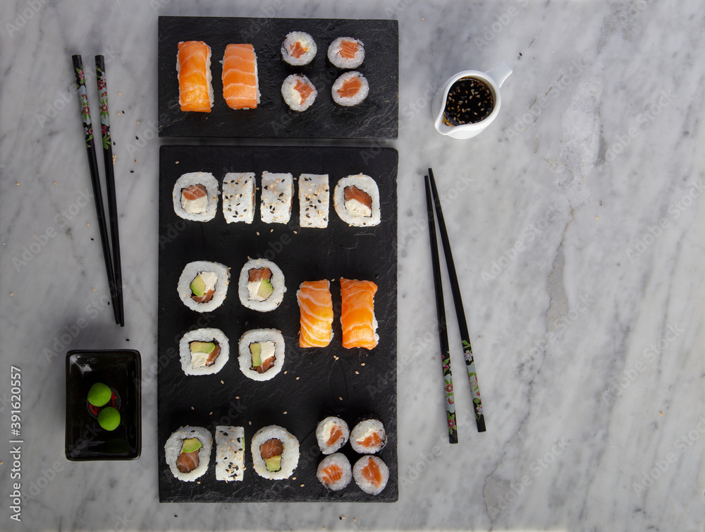 Sushi on plate stone with chopsticks Sushi on plate stone with chopsticks