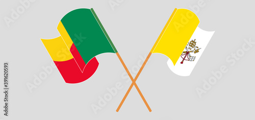 Crossed and waving flags of Vatican and Benin