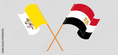 Crossed and waving flags of Vatican and Egypt