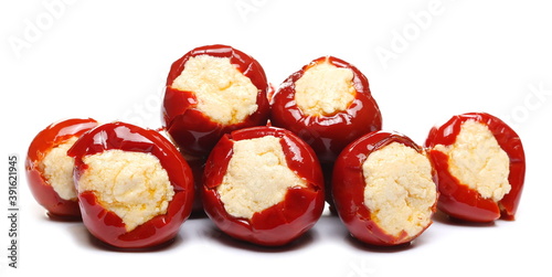 Cherry red peppers stuffed with soft cheese isolated on white background 