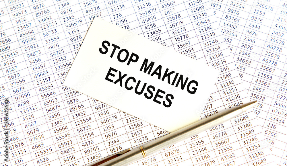 on the business card the text STOP MAKING EXCUSES, next to the pen, the background are reports. on the business card the text STOP MAKING EXCUSES, next to the pen, the background are reports.