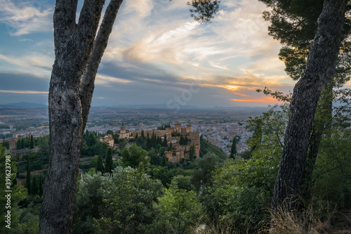 The Alhambra in Granada during a sunset with beautiful views of the city at its best, articulating the landscape with incredible architecture.