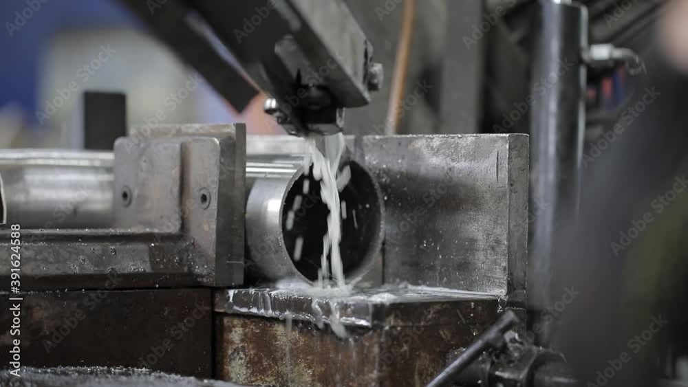 welded seam on a section of a steel pipe with the help of a grinding machine in the metal workshop welded seam on a section of a steel pipe with the help of a grinding machine in the metal workshop