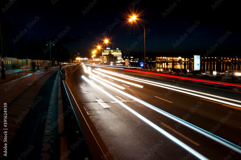 Night city scene with car light trails. light trails on the modern city background. futuristic urban building with light trails. Light trails at night in urban environment