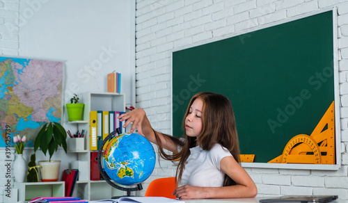 where to go. back to school. teen girl work in classroom near blackboard. cheerful kid learning geography. modern education. knowledge day. child pupil use globe. girl is college student