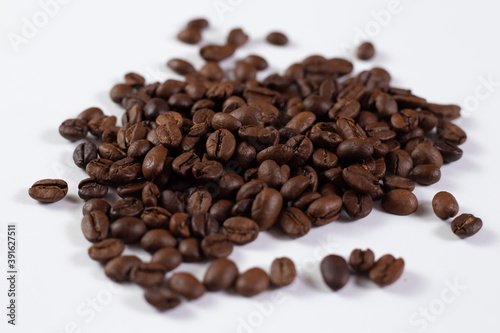 Close up of brown coffee beans on white background
