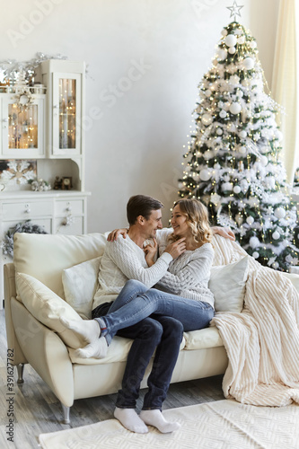 happy couple sitting on sofa at home © Inna Vlasova