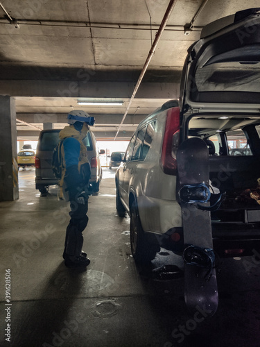 Wallpaper Mural woman near white suv at parking place in snowboard equipment Torontodigital.ca
