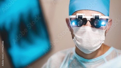 neurosurgeon doctor in glasses with magnifying lenses in the operating room, professional portrait.