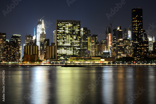 NEW YORK CITY - JUNE 26, 2019: Night view to Manhattan skyline from Gantry Plaza State Park