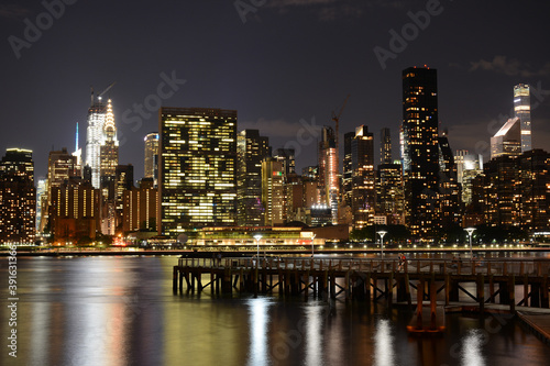 NEW YORK CITY - JUNE 26  2019  Night view to Manhattan skyline from Gantry Plaza State Park