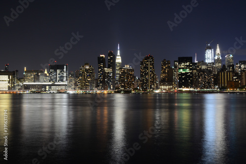 NEW YORK CITY - JUNE 26, 2019: Night view to Manhattan skyline from Gantry Plaza State Park