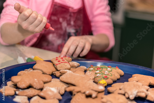 christmas gingerbread biscuits beeing adorned