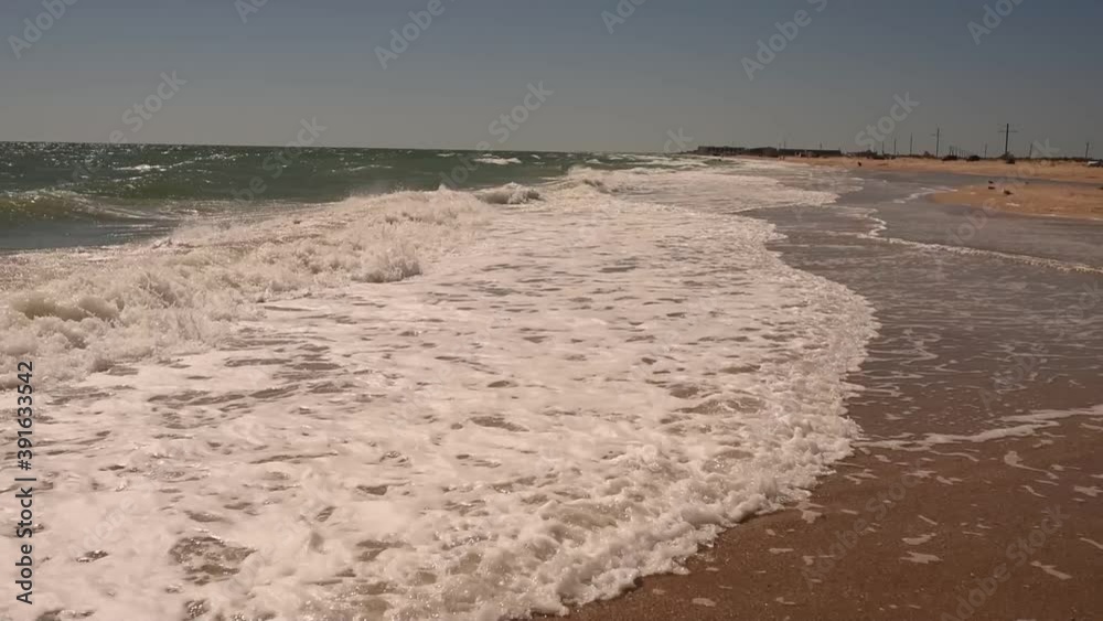 sea waves, Sea foam, light breeze, sandy beach during the day in summer in the sun. Sunny Beach Ukraine Europe Sea of Azov. sea waves, Sea foam, light breeze, sandy beach during the day in summer in the sun. Sunny Beach Ukraine Europe Sea of Azov.