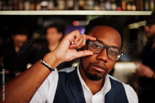 Fotografija Stylish african american man against group of handsome retro well-dressed guys gangsters spend time at club, drinking on bar counter