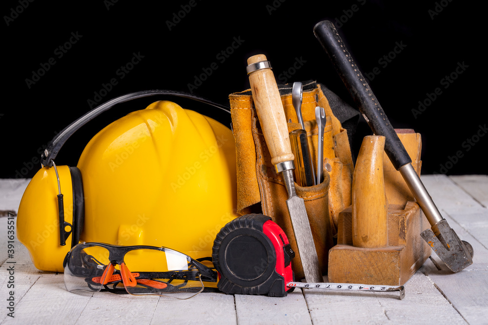 Carpentry tools and a protective helmet. Accessories for work in a home workshop. Carpentry tools and a protective helmet. Accessories for work in a home workshop.