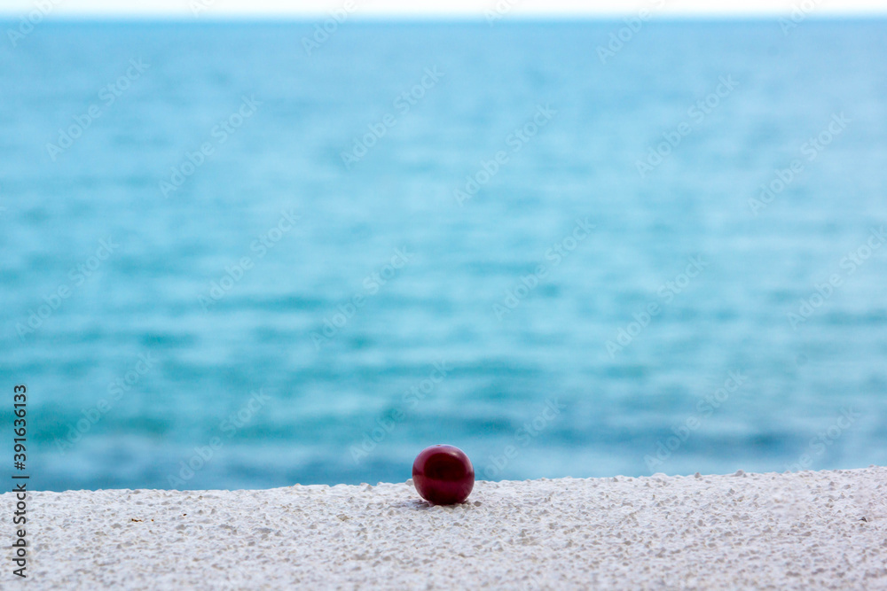 Lonely сherry on the sea background. Summer Lonely сherry on the sea background. Summer