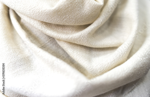 White beige towel texture. Closeup natural cashmere scarf. Light texture background, close up of a fabric