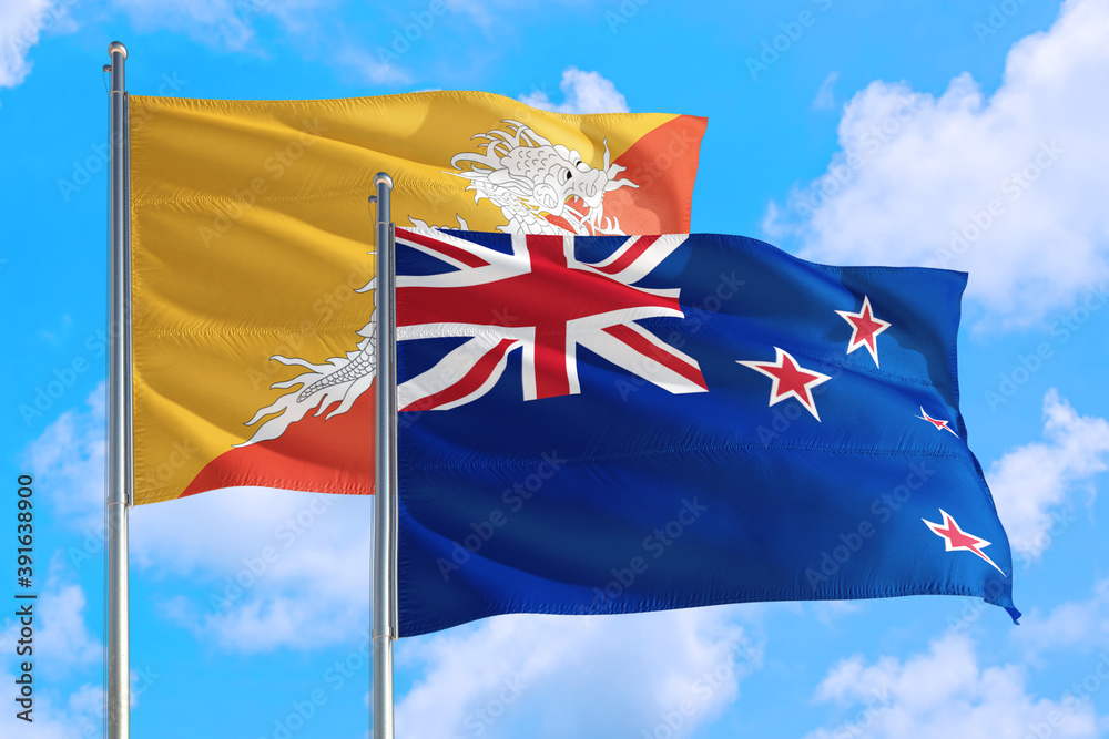 New Zealand and Bhutan national flag waving in the windy deep blue sky. Diplomacy and international relations concept. New Zealand and Bhutan national flag waving in the windy deep blue sky. Diplomacy and international relations concept.