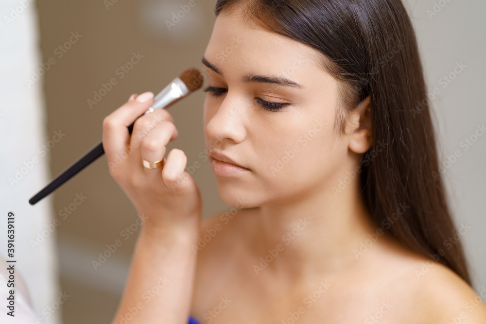 Professional makeup artist working with client in dressing room Professional makeup artist working with client in dressing room