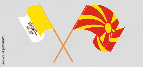 Crossed and waving flags of Vatican and North Macedonia