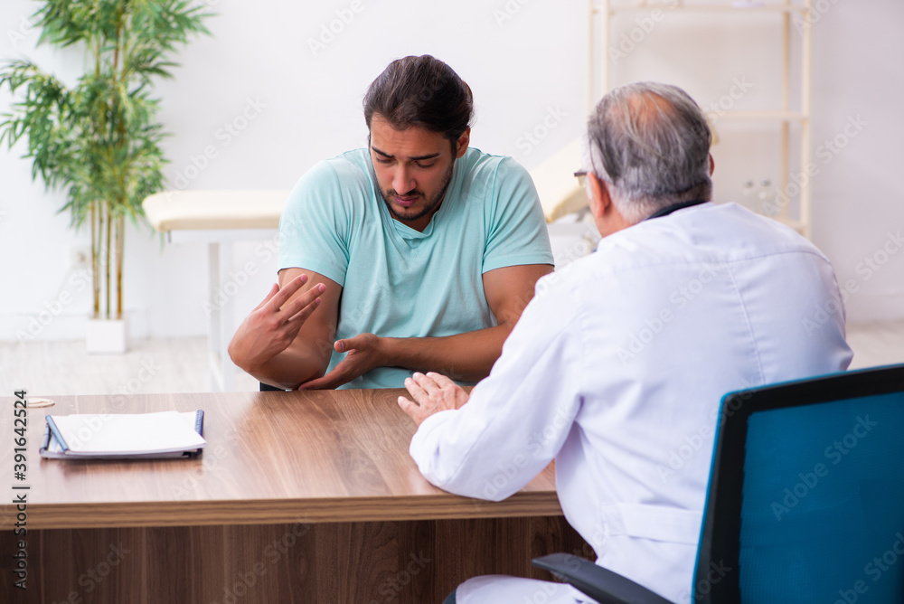 Injured young man visiting old doctor Injured young man visiting old doctor