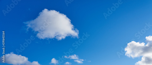 White clouds on s blue sky as a natural background. Copy space.