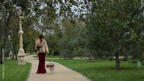 A girl walks her dog in the Park