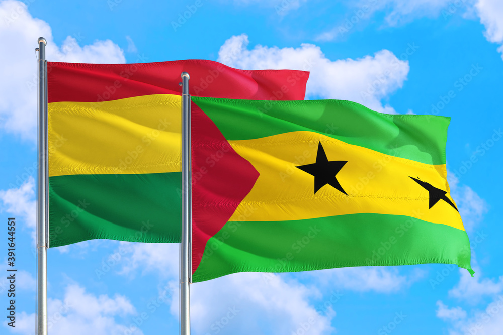 Sao Tome And Principe and Bolivia national flag waving in the windy deep blue sky. Diplomacy and international relations concept. Sao Tome And Principe and Bolivia national flag waving in the windy deep blue sky. Diplomacy and international relations concept.