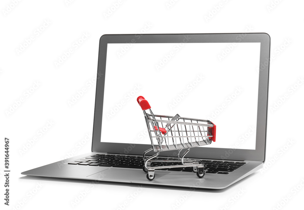 Internet shopping. Laptop with small cart isolated on white