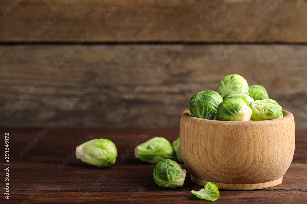 Bowl with fresh Brussels sprouts on brown wooden table, closeup. Space for text Bowl with fresh Brussels sprouts on brown wooden table, closeup. Space for text