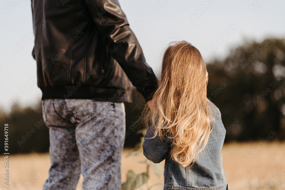 Fototapeta premium Father and daughter walking holding hands