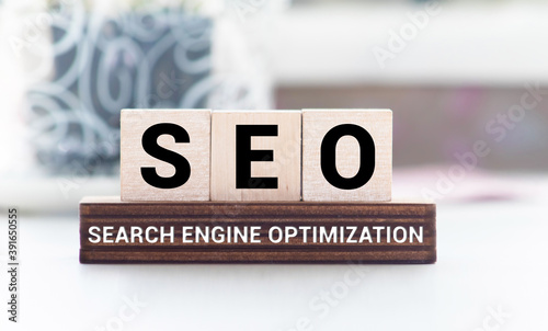 SEO word wooden cubes on a red background