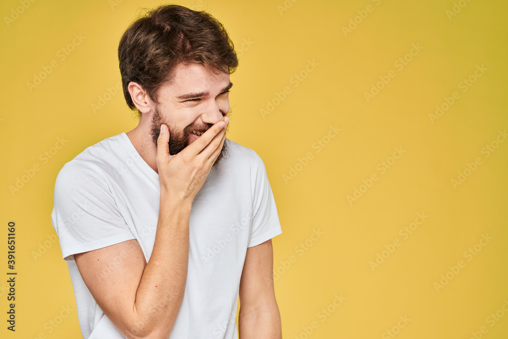 Bearded man white t-shirt emotions gestures with hands fun yellow background Bearded man white t-shirt emotions gestures with hands fun yellow background