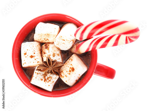 Cup of hot chocolate with marshmallows, Christmas candy cane and anise isolated on white, top view