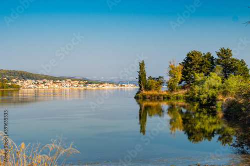 Trees are reflecting at the calm waters of koutavos lagoon near Argostoli in Kefalonia, Greece 