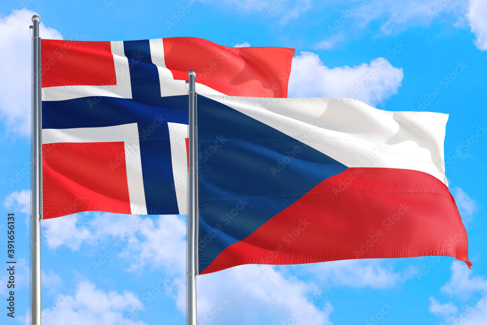 Czech Republic and Bouvet Islands national flag waving in the windy deep blue sky. Diplomacy and international relations concept. Czech Republic and Bouvet Islands national flag waving in the windy deep blue sky. Diplomacy and international relations concept.