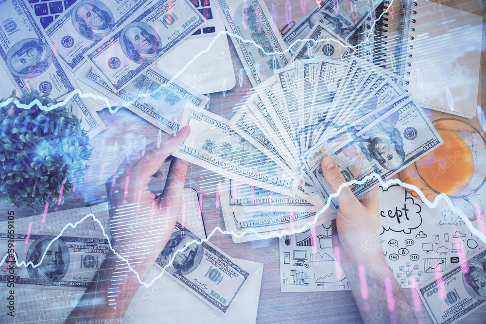 Multi exposure of financial graph drawing hologram and USA dollars bills and man hands. Analysis concept.