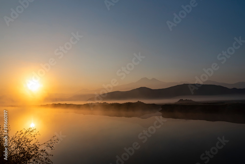 Sunrise with the mist over the river and the plain in Kayseri, in front of Erciyes mountain © attraction art