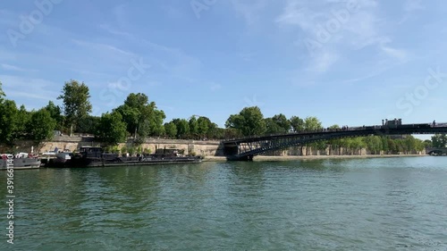Footage of moored boats and people walking on bridge called 