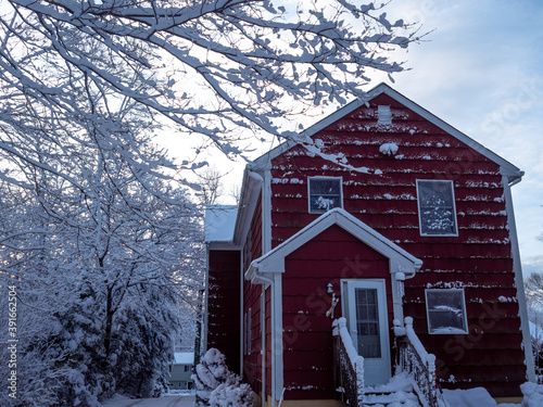 red suburban house in the first snow of winter
