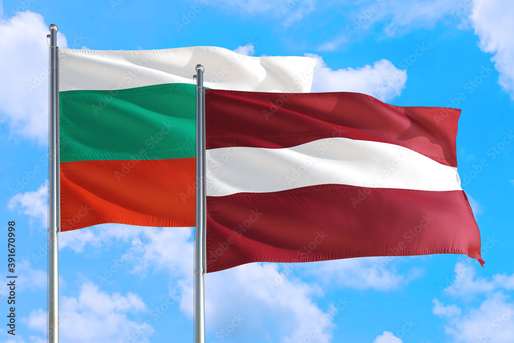 Latvia and Bulgaria national flag waving in the windy deep blue sky. Diplomacy and international relations concept. Latvia and Bulgaria national flag waving in the windy deep blue sky. Diplomacy and international relations concept.