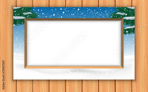 landscape of snow forest in the picture frame on the wooden wall