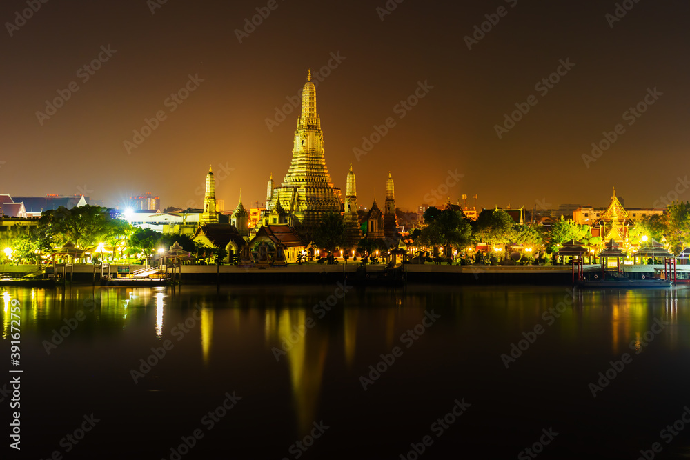 Wat Arun with Chao Phraya river at night in Bangkok, Thailand