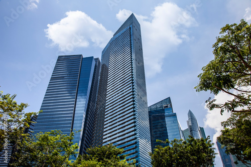 office buildings. Looking Up At Modern Corporate Buildings On A Sunny Day  With Dramatic Clouds  In Singapore. Stock Photo..