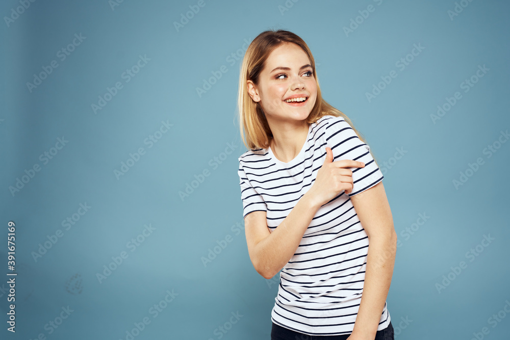 Pretty woman striped t-shirt fun emotions lifestyle blue background Pretty woman striped t-shirt fun emotions lifestyle blue background