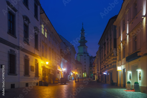 Image of centre of Bratislava with Michael's Gate illuminated at dusk, Slovakia..