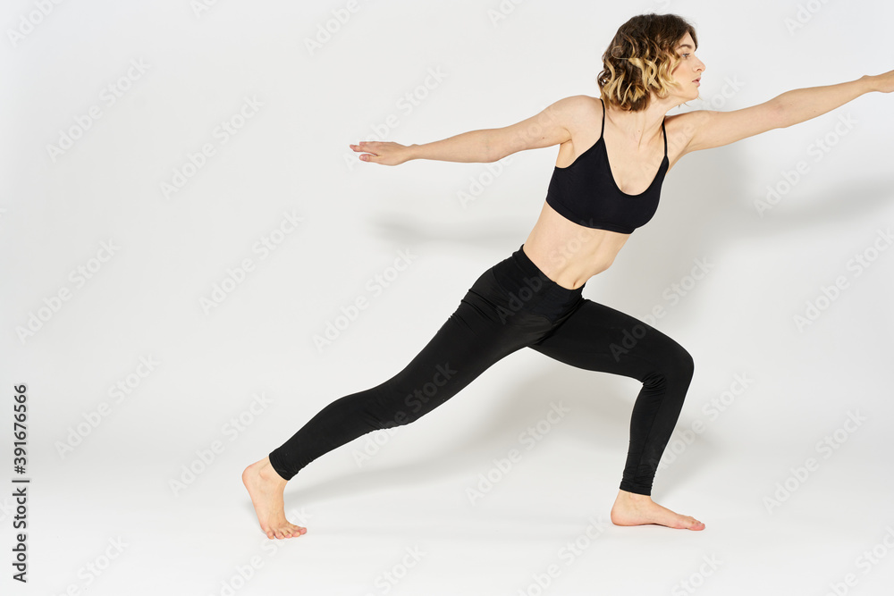 Woman in sportswear is engaged in fitness indoor gymnastics slim figure Woman in sportswear is engaged in fitness indoor gymnastics slim figure