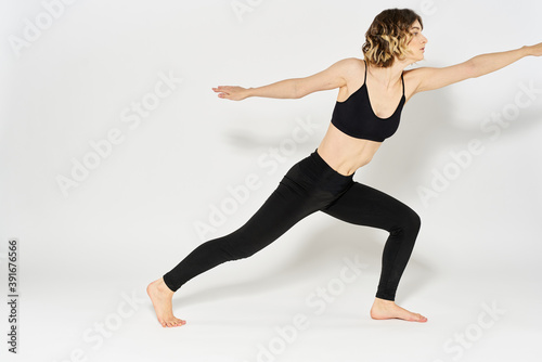 Woman in sportswear is engaged in fitness indoor gymnastics slim figure